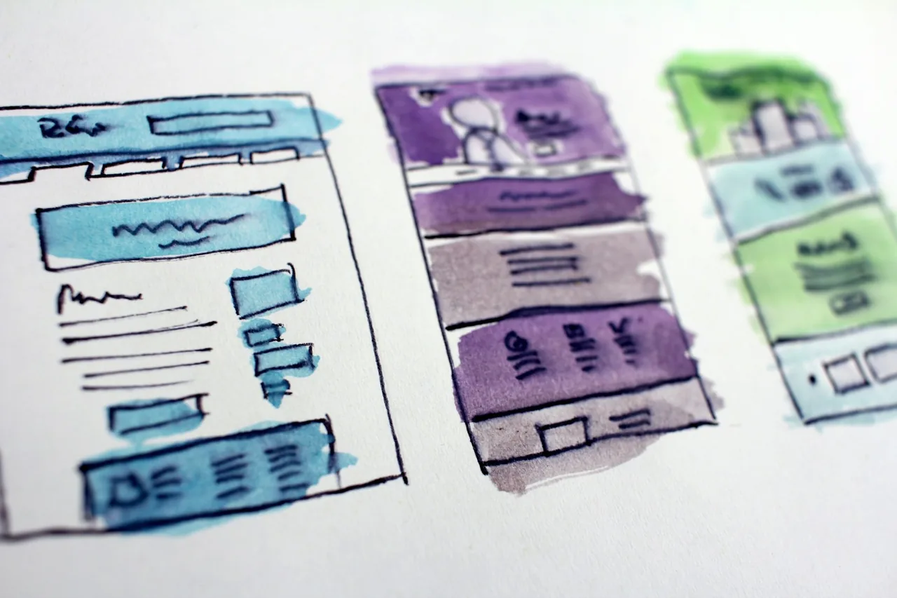 Designer reviewing a website wireframe on a laptop